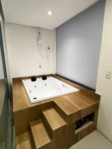 a bathroom with a bath tub with a sink at Hotel Villa Babaçu in Jacobina