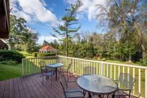 a deck with tables and chairs and a fence at Best Western Plus Otonabee Inn in Peterborough