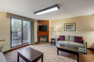 a living room with a couch and a fireplace at Best Western Plus Otonabee Inn in Peterborough