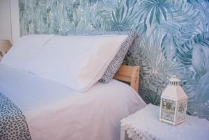 a bedroom with a bed and a tropical wallpaper at Villa Magnolia con giardino in Bari