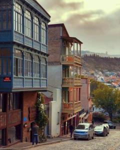 a group of buildings on a city street with cars parked at Littele paradise in Tbilisi City