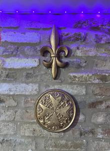 a gold coin on a brick wall with purple lights at Cross Keys Hotel Chatteris in Chatteris