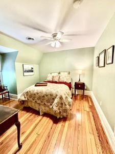 a bedroom with a bed and a ceiling fan at MacFie House in Cape Girardeau