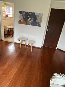 two stools in a room with a wooden floor at Apartamento Centro ao lado do Country Club in Nova Friburgo +27 photos