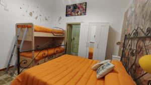 a bedroom with a bed with an orange bedspread at Orange Lemon in Palermo