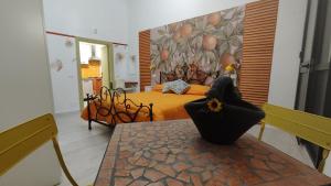 a bedroom with a bed with a painting on the wall at Orange Lemon in Palermo