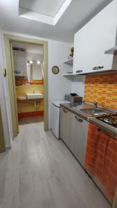 a kitchen with a sink and a stove top oven at Orange Lemon in Palermo
