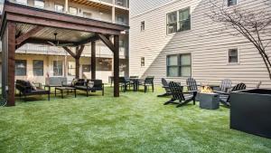 a patio with chairs and tables and a fire pit at CozySuites MusicRow Astonishing SDO with free parking 08 in Nashville