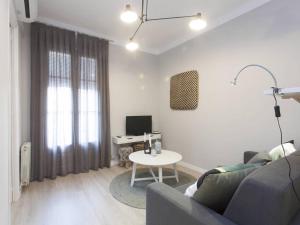 a living room with a couch and a table at 52ROC1069 - New 2BR Flat near Plaza Espana in Barcelona