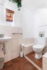 a white bathroom with a toilet and a sink at 20 seconds to Charles Bridge in Prague +16 photos