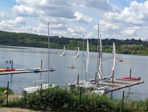 a group of sailboats on a lake with a dock at Charmante ancienne grange in Villevaudé