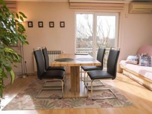 a living room with a wooden table and chairs at Quietude in Visnjevac in Višnjevac