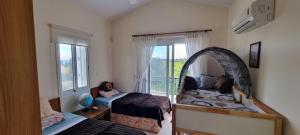 a bedroom with a mirror and a bed and a window at Fab Sea and Mountain View Villa, walking distance from the Sandy Beach in Yialia +22 photos