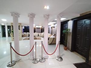 a lobby with white columns and a red rope at شقق الاحلام بحراء للايجار الشهري والسنوي in Jeddah