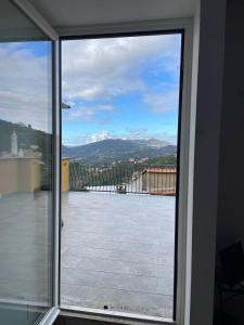 a view from a sliding glass door of a balcony at Magico Appartamento in Liguria Vista Mare in Cogorno