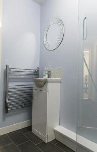 a bathroom with a sink and a mirror at St Luke's 2 in Liverpool