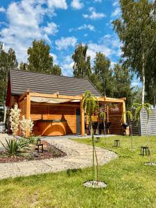 a log cabin with a gambrel roof at Apartamenty KAHOY balia pomost Kozin in Kozin