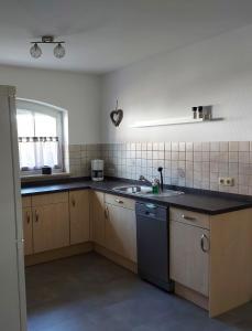 a kitchen with a sink and a counter top at Ferienparadies Farn in Oppenau +1 photo