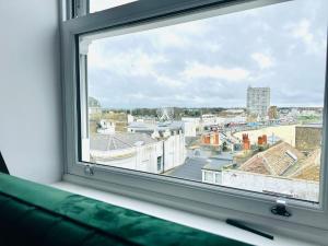 a window with a view of a city at Margate Spacious Apartment - 5 min walk to beach in Margate