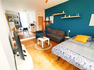 a living room with a bed and a couch at Beau studio indépendant in Arraute-Charritte