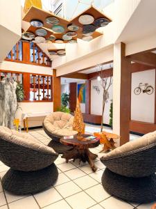 a lobby with chairs and a table in a building at Hotel Sexta Avenida in Tapachula