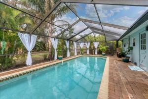an indoor swimming pool with a glass ceiling at Beach Cottage with heated pool just off Siesta Key in Sarasota