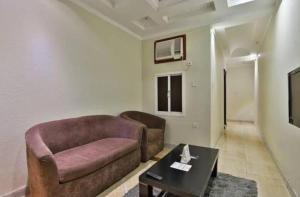 a living room with a couch and a coffee table at شقق الاحلام بحراء in Jeddah