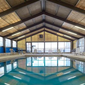 a swimming pool with blue water in a building at Ashworth by the Sea in Hampton