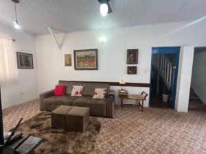 a living room with a couch and a table at Casa Beppe in Águas de Santa Barbara