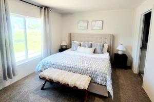 a bedroom with a large bed and a window at The perfect get away home in Garden City