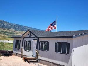 a house with an american flag on top of it at The perfect get away home in Garden City