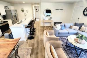 a living room with a couch and a table at The perfect get away home in Garden City