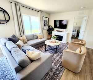 a living room with a couch and two chairs at The perfect get away home in Garden City