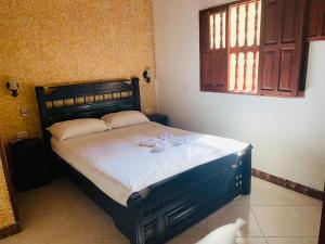 a bedroom with a bed with a towel on it at CASA MORALES in Santa Fe de Antioquia