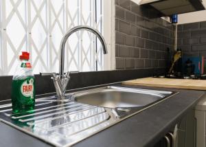 a kitchen sink with a soda bottle on it at St Luke's 2 in Liverpool