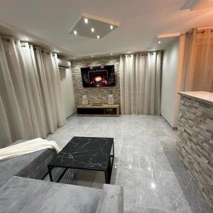 a living room with a couch and a fireplace at T3 5 étoile jacuzzi in Toulouse