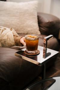 a person holding a cup of coffee on a table at Villa Las Mil Flores in Antigua Guatemala