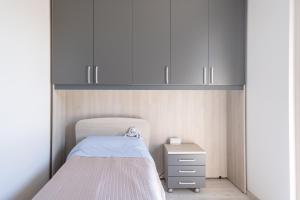 a small bedroom with a bed and white cabinets at residence borgo secolo in Peschiera del Garda +45 photos