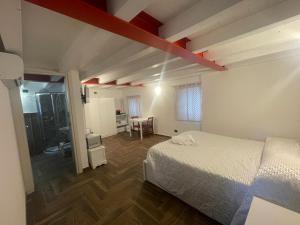 a bedroom with a bed and a room with a bathroom at Casa Borgata in Grondona