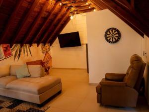 麦德林Luxury Living in Parque Lleras & Full House的客厅里有一张沙发，墙上挂着一只钟