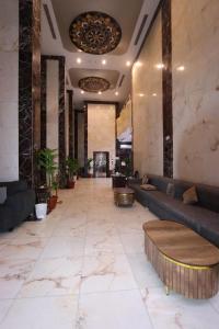 a lobby with couches and tables in a building at فندق رفاق Refaq Hotel in Makkah