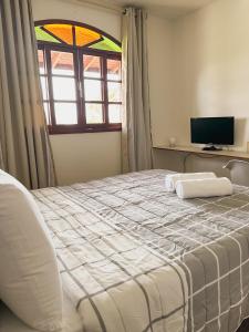 Morada Verde - AP 2 quartos tesisinde bir odada yatak veya yataklar