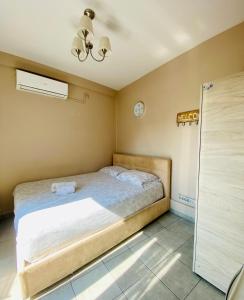 a bedroom with a bed and a clock on the wall at Elegant Studio in the center of city. in Thessaloniki