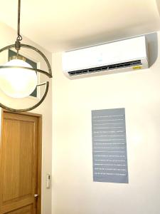 a ceiling fan with a light and a sign on a wall at Central Luxury Louvre Opera 3rd Floor in Paris