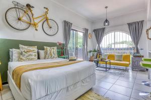a bedroom with a bed with a bike on the wall at The Spanish House in Centurion