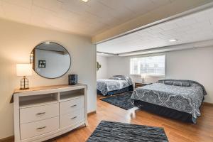 a bedroom with two beds and a mirror at Walk to Lake Beach Glenwood Vacation Rental! in Glenwood