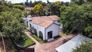 an aerial view of a white house with trees at The Spanish House in Centurion