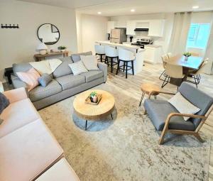 a living room with a couch and a table at New house ready for you in Garden City