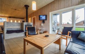 sala de estar con mesa y chimenea en Beautiful Home In Haderslev With 4 Bedrooms, Sauna And Wifi, en Årøsund