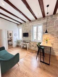 a living room with a stone wall and a table at Agora in Split
